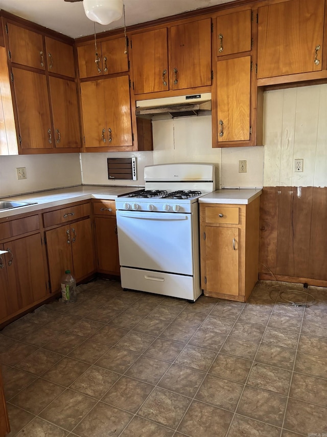 513 Joyce, Searcy, AR 72143 - kitchen featuring gas range gas stove, under cabinet range hood, brown cabinets, and light countertops