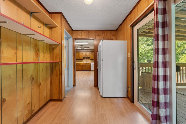 7025 Windsong, North Little Rock, AR 72113 - hallway with light wood-type flooring, wood walls, and a textured ceiling