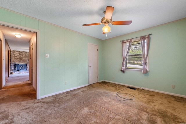 7025 Windsong, North Little Rock, AR 72113 - unfurnished bedroom with carpet floors, a brick fireplace, a ceiling fan, a textured ceiling, and ornamental molding