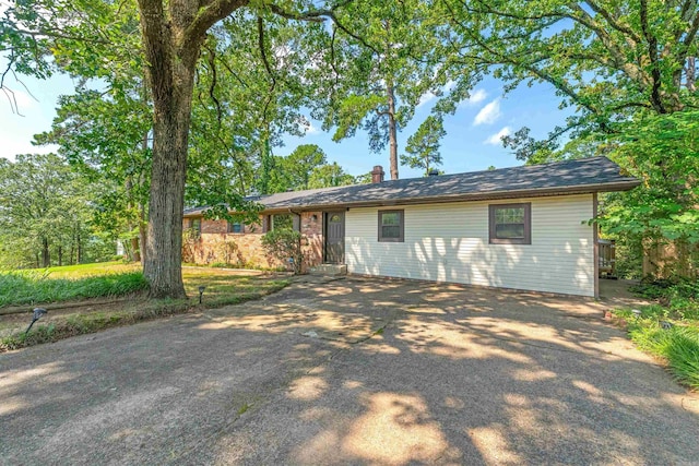 7025 Windsong, North Little Rock, AR 72113 - back of property with driveway and a chimney