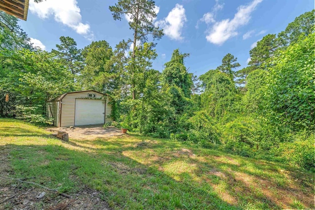 7025 Windsong, North Little Rock, AR 72113 - view of grassy yard featuring an outbuilding and a garage