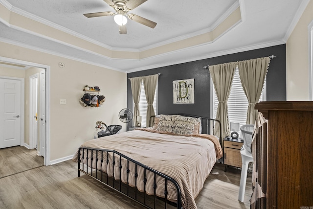19 Mustang, Cabot, AR 72023 - bedroom featuring light wood-style floors, a tray ceiling, ornamental molding, and ceiling fan