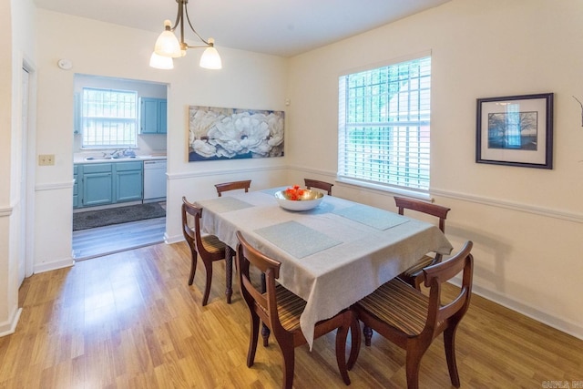4624 W 29th St, Little Rock, AR 72204 - dining area with light wood-type flooring and a chandelier