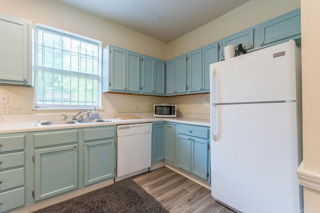 4624 W 29th St, Little Rock, AR 72204 - kitchen featuring white appliances, light wood finished floors, light countertops, and blue cabinets