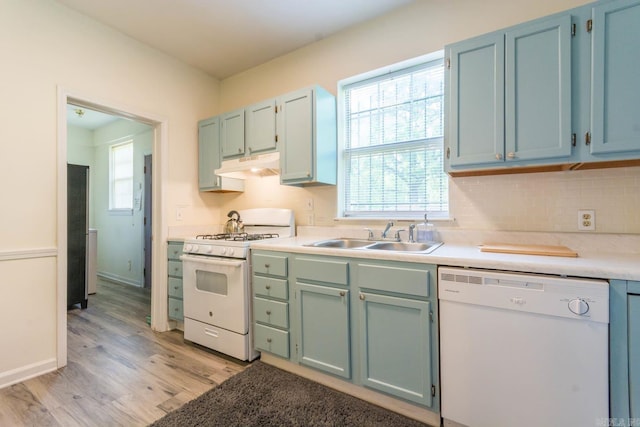 4624 W 29th St, Little Rock, AR 72204 - kitchen with white appliances, under cabinet range hood, light wood finished floors, and light countertops