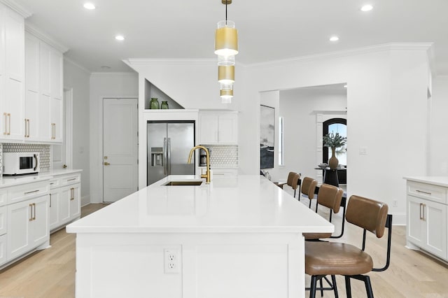 153 Caurel Cir, Little Rock, AR 72223 - kitchen with stainless steel refrigerator with ice dispenser, backsplash, light wood-style flooring, recessed lighting, and white microwave