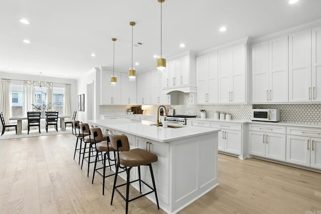 153 Caurel Cir, Little Rock, AR 72223 - kitchen featuring white microwave, light wood-style flooring, light countertops, white cabinets, and recessed lighting