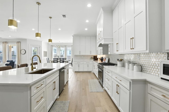 153 Caurel Cir, Little Rock, AR 72223 - kitchen featuring stainless steel appliances, light countertops, a center island with sink, white cabinetry, and recessed lighting