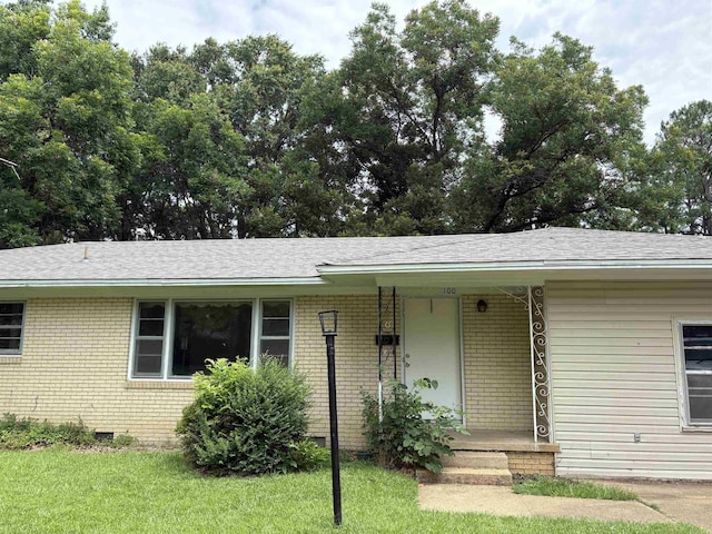 100 E Lincoln Ave, Searcy, AR 72143 - view of front of home with brick siding, a porch, a shingled roof, and a front lawn