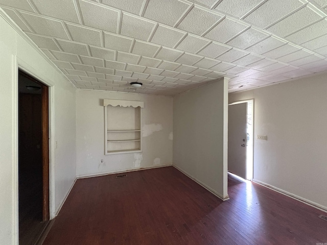 100 E Lincoln Ave, Searcy, AR 72143 - empty room featuring dark wood finished floors and built in shelves