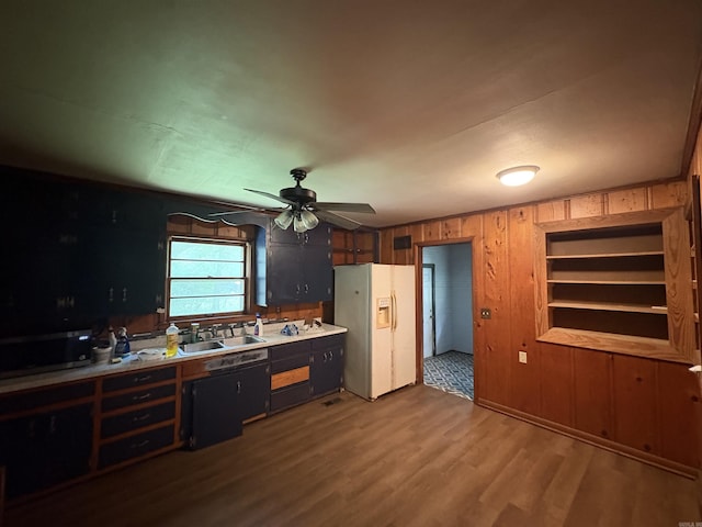 100 E Lincoln Ave, Searcy, AR 72143 - kitchen with white fridge with ice dispenser, wood finished floors, wood walls, ceiling fan, and light countertops