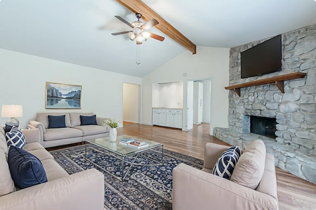 81 Stoneledge Dr, Maumelle, AR 72113 - living room with wood finished floors, a ceiling fan, and a stone fireplace