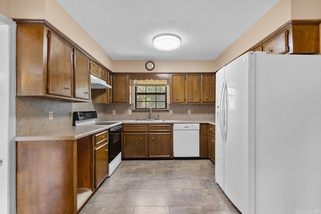 12605 Janelle Ct, Little Rock, AR 72205 - kitchen with white appliances, under cabinet range hood, light countertops, backsplash, and a textured ceiling