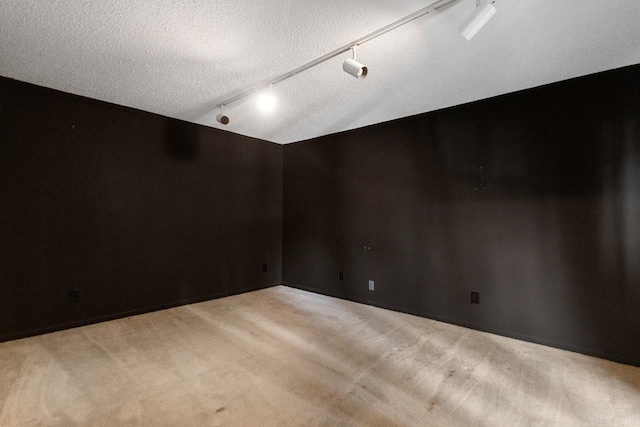 12605 Janelle Ct, Little Rock, AR 72205 - spare room featuring rail lighting, light carpet, and a textured ceiling