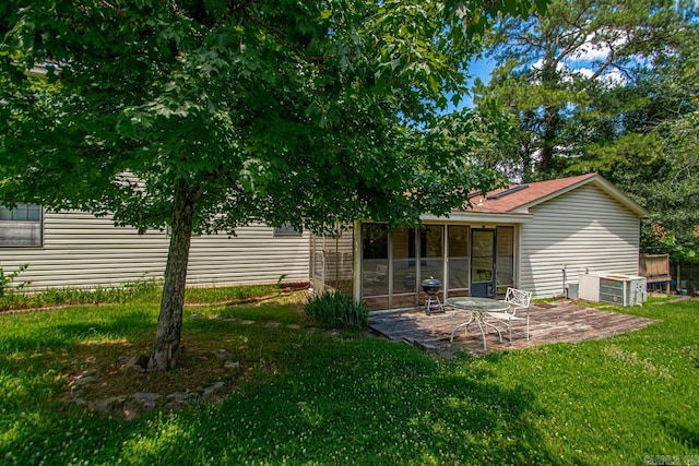 12605 Janelle Ct, Little Rock, AR 72205 - rear view of house with a patio area, a yard, and a sunroom