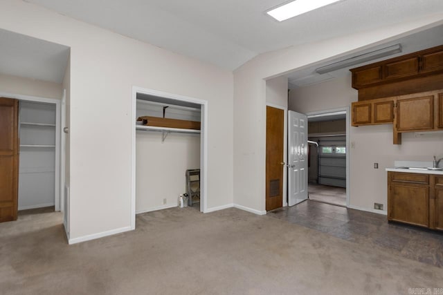 12605 Janelle Ct, Little Rock, AR 72205 - kitchen with brown cabinetry, carpet floors, and light countertops