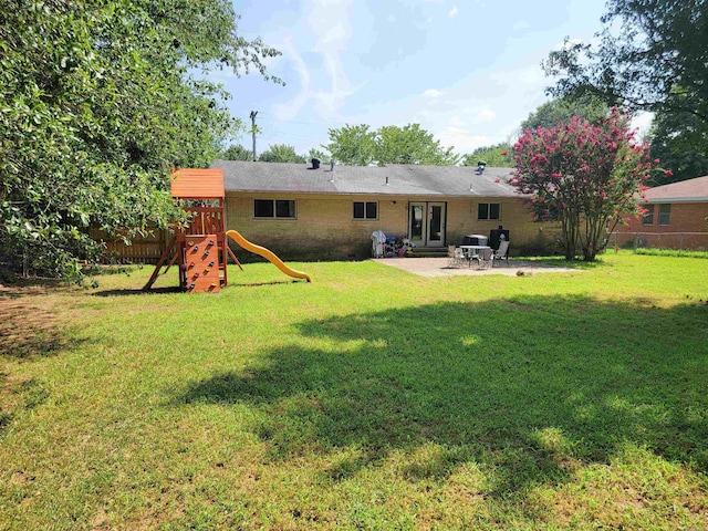 1209 Cole Ave, Mena, AR 71953 - rear view of house with a patio, a playground, and brick siding