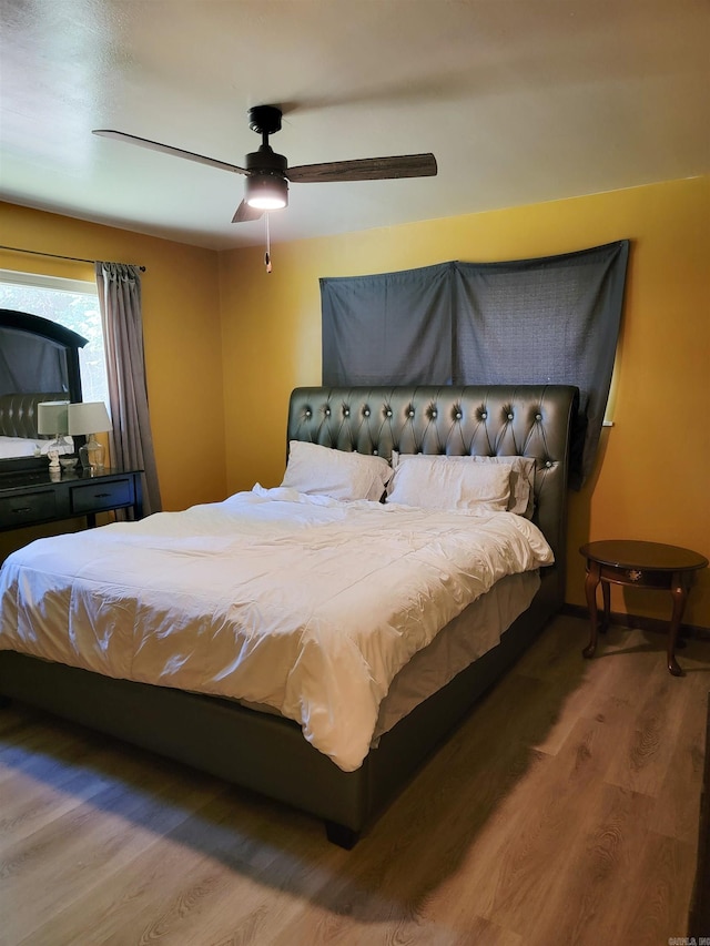 1209 Cole Ave, Mena, AR 71953 - bedroom featuring wood finished floors and a ceiling fan