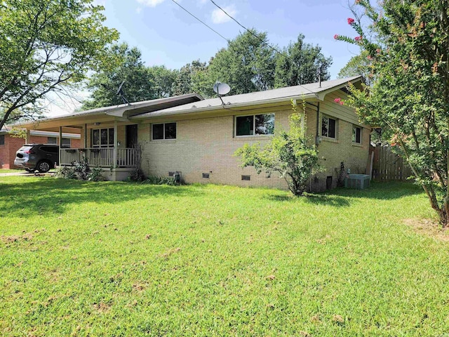 1209 Cole Ave, Mena, AR 71953 - rear view of property with crawl space, brick siding, and a carport