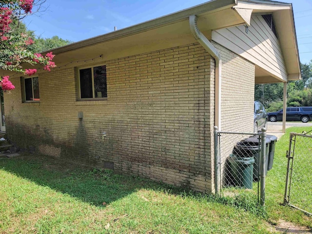 1209 Cole Ave, Mena, AR 71953 - view of side of home with brick siding and a carport