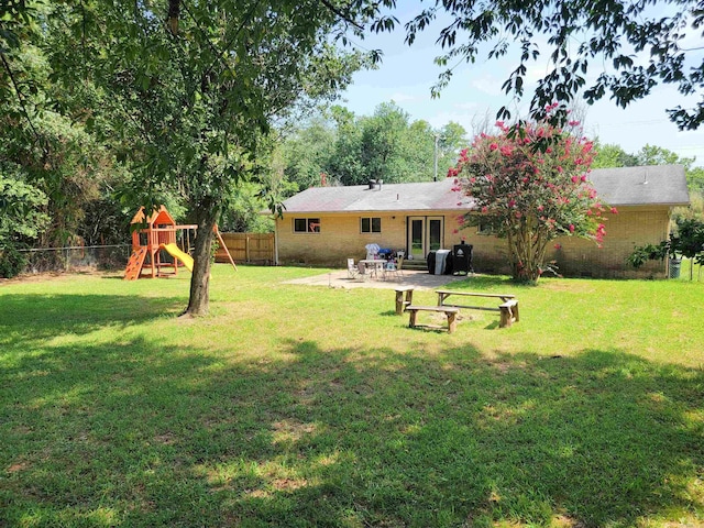 1209 Cole Ave, Mena, AR 71953 - fenced backyard featuring a patio area and a playground