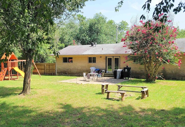 1209 Cole Ave, Mena, AR 71953 - rear view of property featuring a patio, french doors, brick siding, crawl space, and a playground