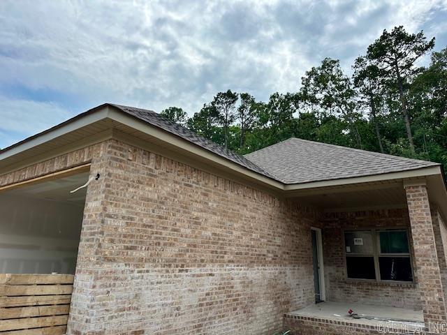 13423 Teton Dr, Little Rock, AR 72211 - view of side of property with brick siding and roof with shingles
