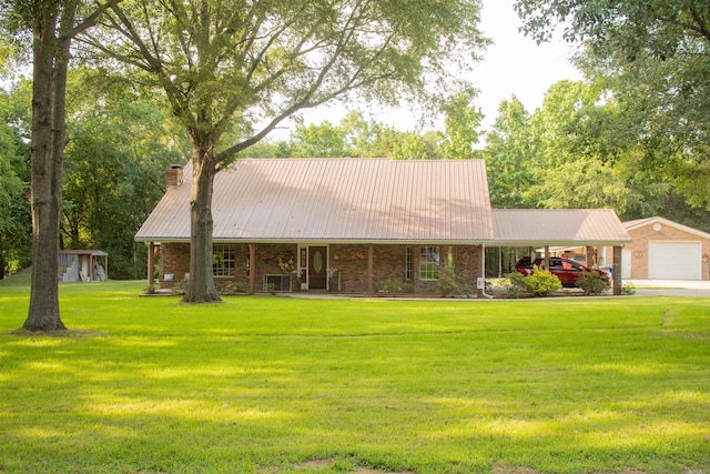 85 Linder Rd, Greenbrier, AR 72058 - view of front of home featuring covered porch, a front lawn, an outbuilding, a chimney, and a metal roof