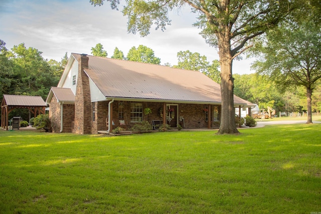 85 Linder Rd, Greenbrier, AR 72058 - rear view of house featuring covered porch, a lawn, a metal roof, and brick siding