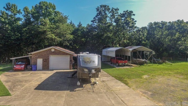 85 Linder Rd, Greenbrier, AR 72058 - view of front of property featuring a front yard, a garage, an outbuilding, and brick siding
