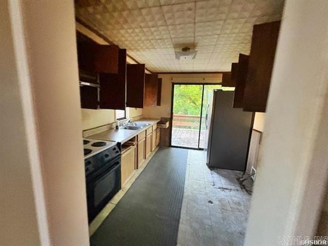6430 Park Ave, Hot Springs, AR 71901 - kitchen featuring freestanding refrigerator, electric range, light countertops, and refrigerator