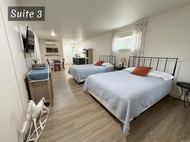 263 Jimmy Driftwood Pkwy, Mountain View, AR 72560 - bedroom featuring light wood-style flooring and an AC wall unit