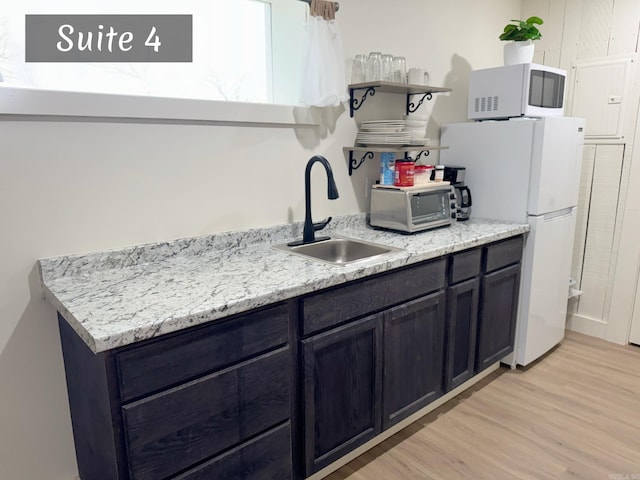 263 Jimmy Driftwood Pkwy, Mountain View, AR 72560 - kitchen with white appliances, open shelves, and light wood-style flooring