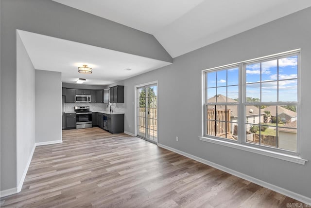 2002 Reagan Cv, Alexander, AR 72002 - kitchen with stainless steel appliances, light countertops, light wood-style floors, backsplash, and vaulted ceiling