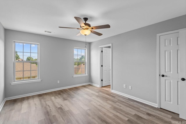 2002 Reagan Cv, Alexander, AR 72002 - unfurnished bedroom with multiple windows, wood finished floors, and ceiling fan