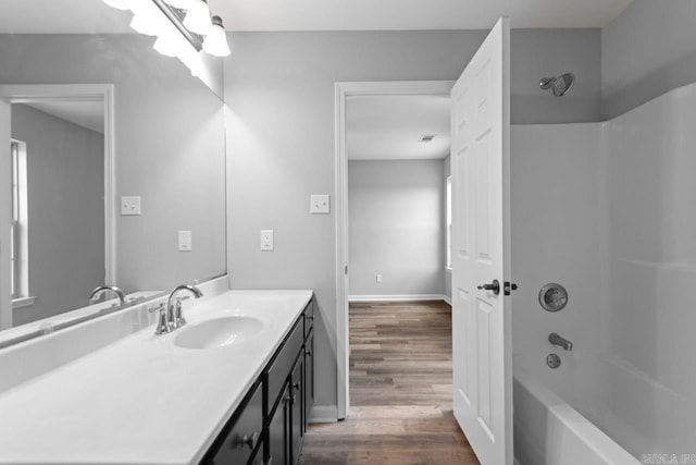 2002 Reagan Cv, Alexander, AR 72002 - bathroom with vanity, wood finished floors, and bathing tub / shower combination