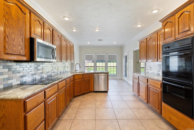 930 Enderlin, Conway, AR 72034 - kitchen featuring black appliances, a peninsula, brown cabinets, tasteful backsplash, and recessed lighting