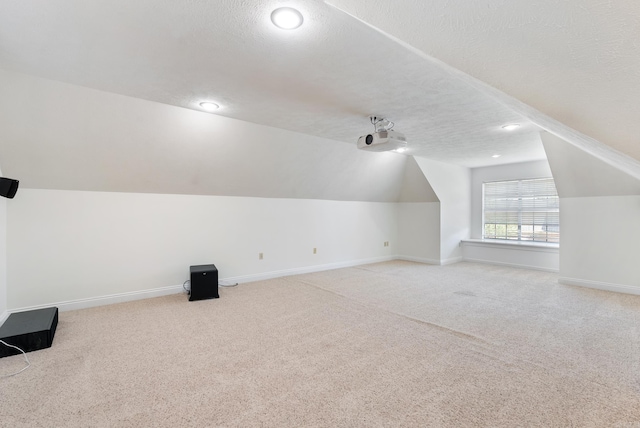 930 Enderlin, Conway, AR 72034 - additional living space featuring carpet flooring, a textured ceiling, vaulted ceiling, and recessed lighting