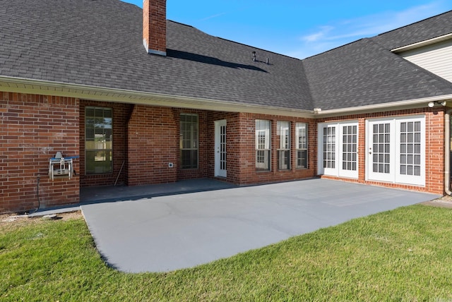930 Enderlin, Conway, AR 72034 - rear view of house with a shingled roof, a chimney, brick siding, a patio, and a yard