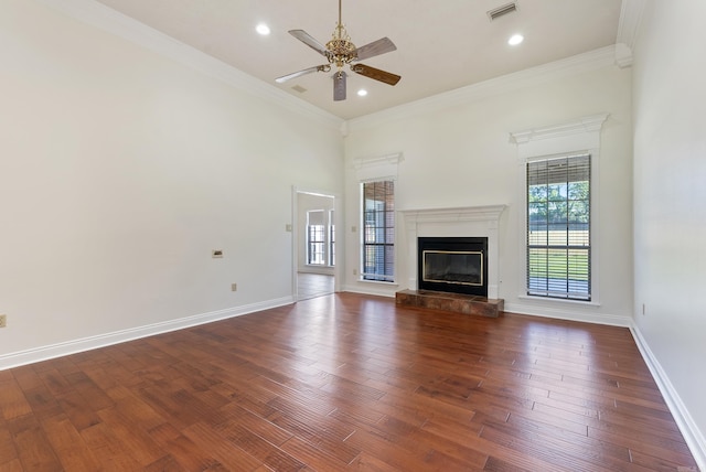 930 Enderlin, Conway, AR 72034 - unfurnished living room with healthy amount of natural light, a ceiling fan, dark wood-style flooring, a glass covered fireplace, and ornamental molding