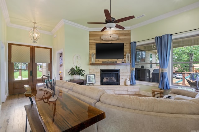 13518 Pikes Peak Pl, Rogers, AR 72756 - living room featuring healthy amount of natural light, hardwood / wood-style flooring, crown molding, ceiling fan, and a fireplace