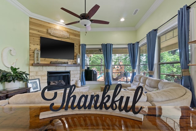 13518 Pikes Peak Pl, Rogers, AR 72756 - living room with ornamental molding, a ceiling fan, a stone fireplace, wooden walls, and recessed lighting