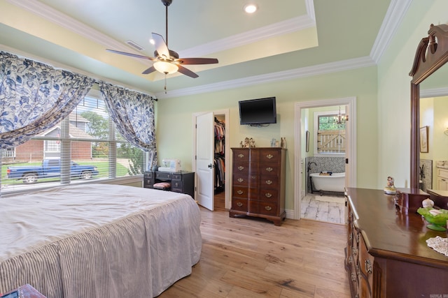 13518 Pikes Peak Pl, Rogers, AR 72756 - bedroom featuring a tray ceiling, a spacious closet, light wood-type flooring, ornamental molding, and ensuite bath