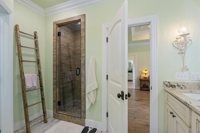 13518 Pikes Peak Pl, Rogers, AR 72756 - bathroom with ornamental molding, vanity, a stall shower, and wood finished floors