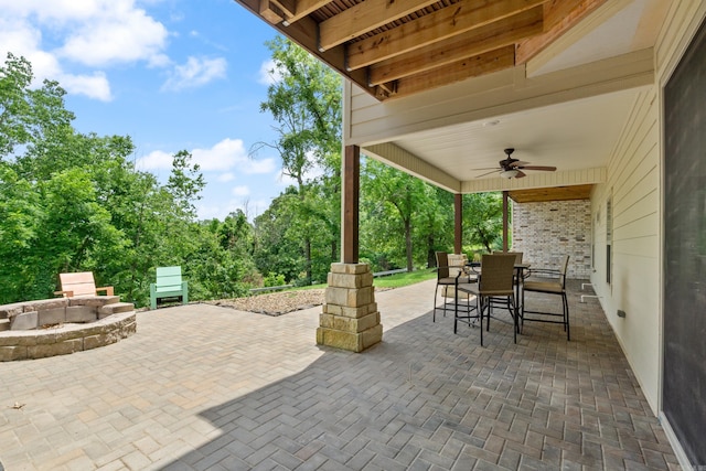 13518 Pikes Peak Pl, Rogers, AR 72756 - view of patio featuring ceiling fan, outdoor dining area, and a fire pit