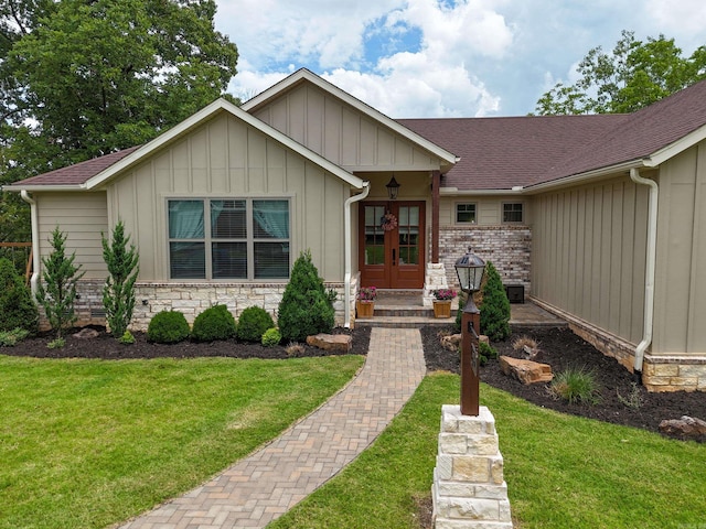 13518 Pikes Peak Pl, Rogers, AR 72756 - view of front of home featuring french doors, a front lawn, board and batten siding, and roof with shingles