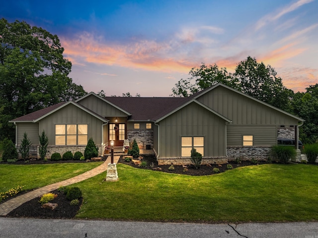 13518 Pikes Peak Pl, Rogers, AR 72756 - view of front of property featuring board and batten siding, a yard, and stone siding