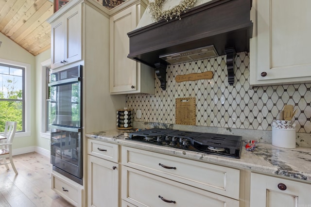 13518 Pikes Peak Pl, Rogers, AR 72756 - kitchen with extractor fan, double oven, black gas stovetop, backsplash, and light stone counters