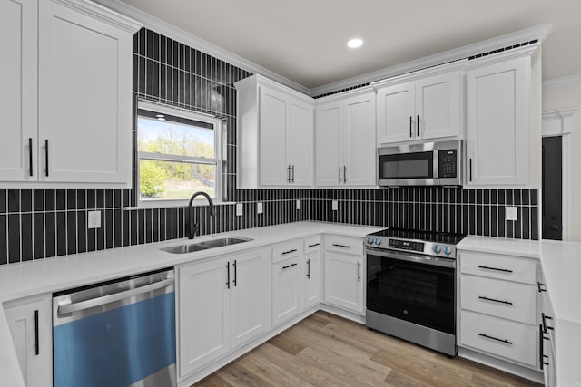 7213 Stonehenge Dr, Sherwood, AR 72120 - kitchen featuring stainless steel appliances, light countertops, backsplash, ornamental molding, and white cabinets