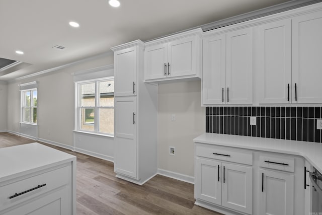 7213 Stonehenge Dr, Sherwood, AR 72120 - kitchen with decorative backsplash, white cabinetry, recessed lighting, light wood-style flooring, and light countertops